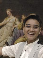 A detail still image of a smiling girl in front of a painting in a gallery